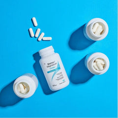 Biomax magnesium citrate capsules 250mg bottle with capsules on blue background.