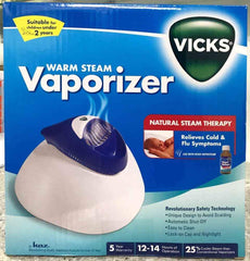 Vicks Warm Steam Vaporiser with 100ml Inhalant for cough and cold relief, featuring automatic shut-off and safety design.
