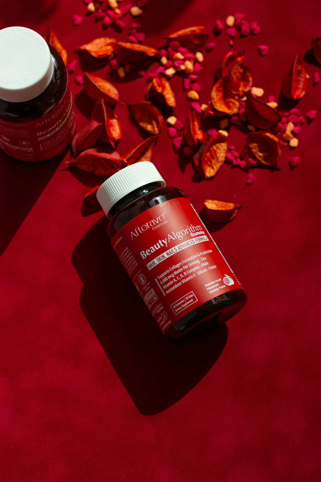 A bottle of vitamins sitting on top of a red table