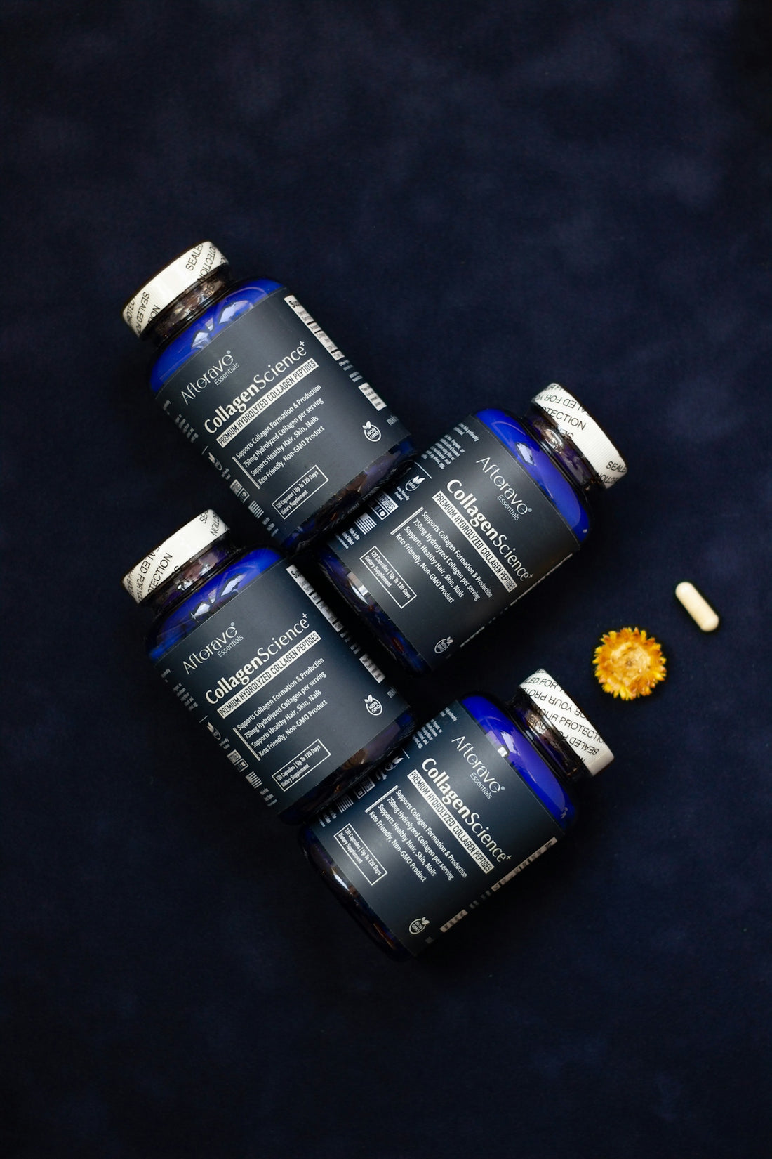 Four bottles of vitamins sitting on top of a table