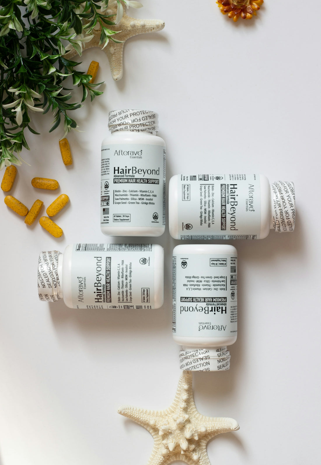 Four bottles of vitamins sitting on top of a starfish