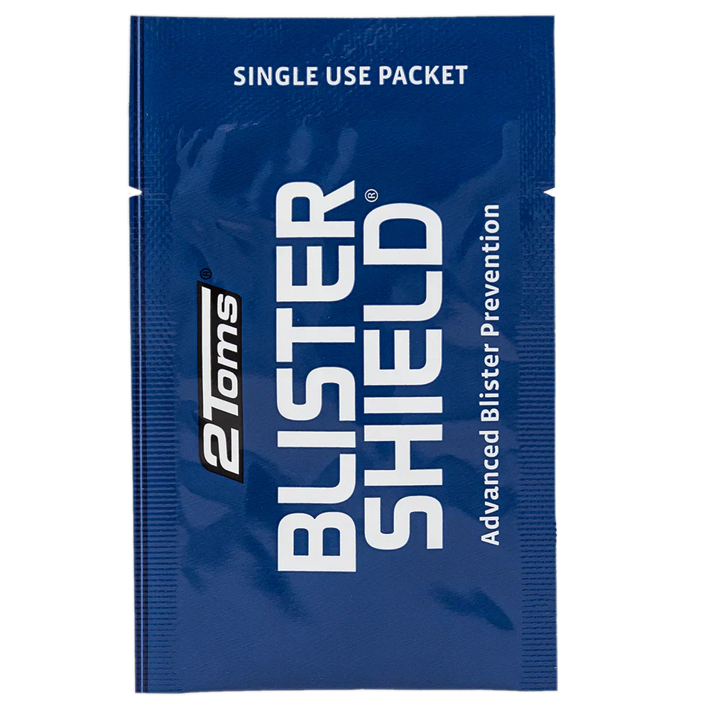 Blue 2TOMS BlisterShield single-use packet with bold vertical BlisterShield branding.