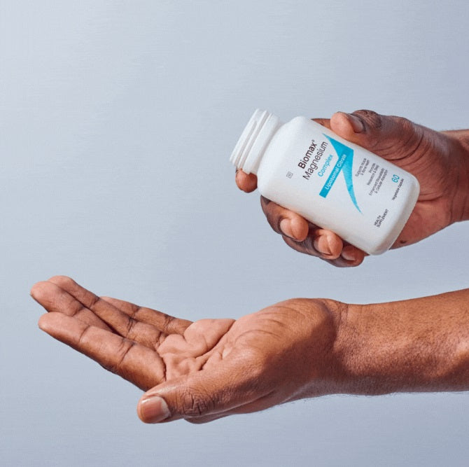 Biomax magnesium citrate capsules being held above an open palm