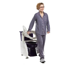 Woman in pajamas demonstrating the Allied Medical electric toilet lift seat for independent use.
