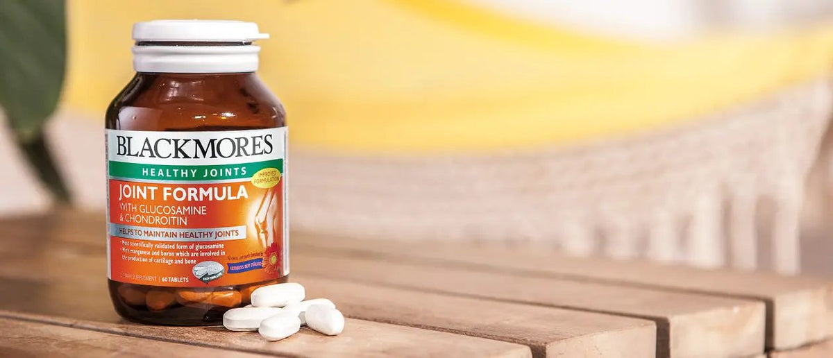 Blackmores joint formula with glucosamine & chondroitin 60 tablets on wooden surface with pills.