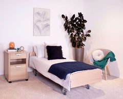 Modern bedroom featuring a Bock® v2 adjustable electric bed with contemporary decor and plant.